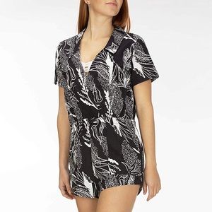 Hurley romper with floral print black and white  collared from and slit in back